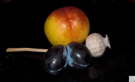 still of plums, poppy capsule and peach before black background, 